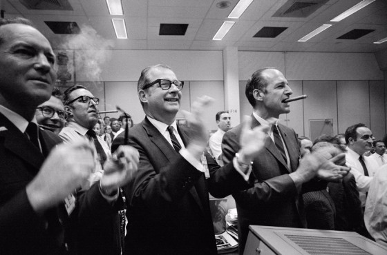 Dr. Thomas Paine (center of frame) and other NASA staff members applaud the successful splashdown of the Apollo 13 mission.