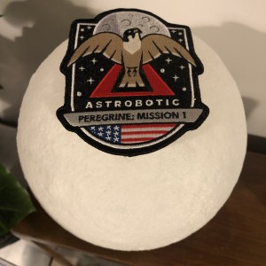 PM-1 mission patch balanced on a 3D printed Moon lamp